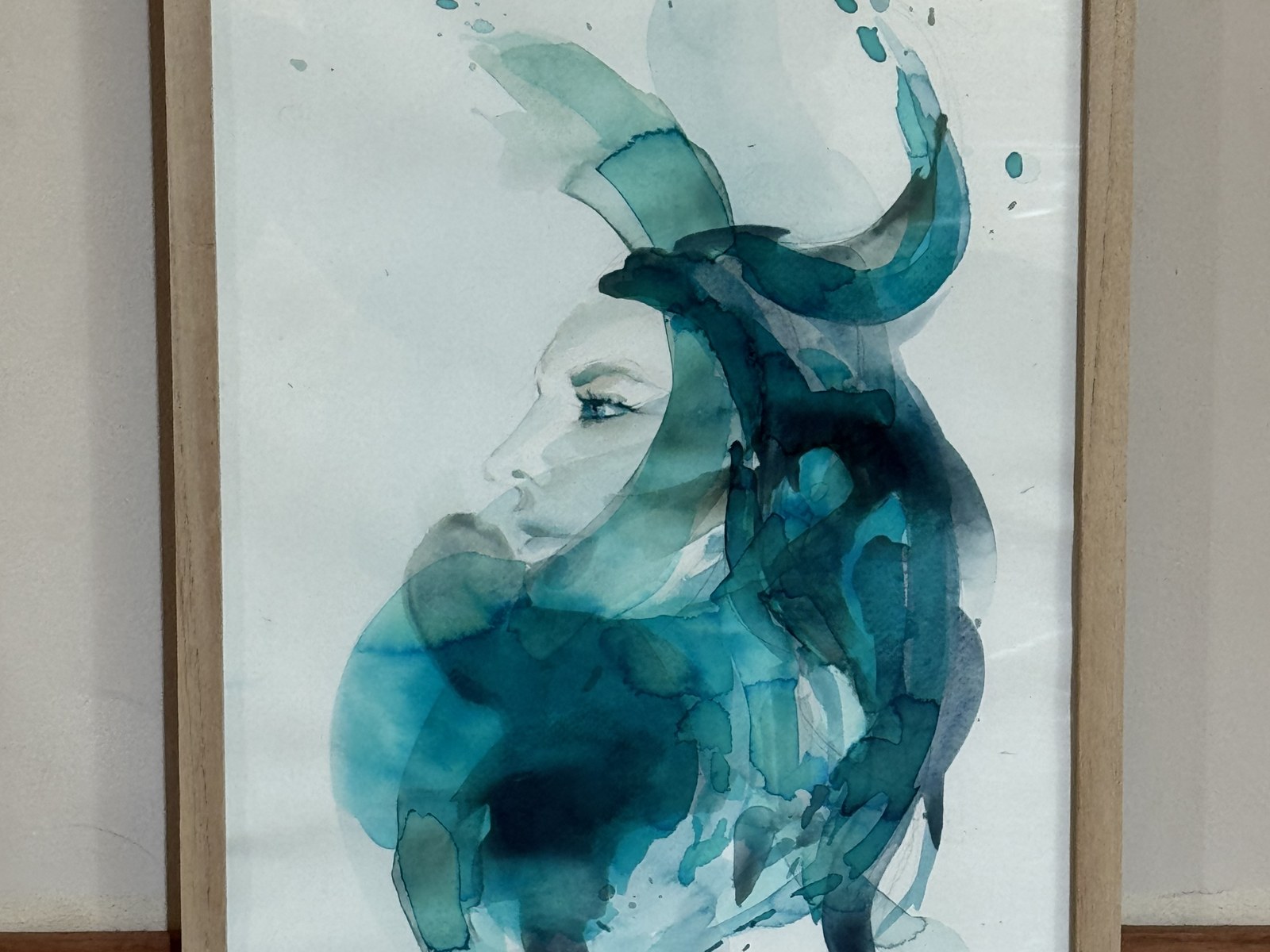 Framed teal and blue watercolour portrait of a woman's face in profile — AGUAS by Brenda Rodríguez