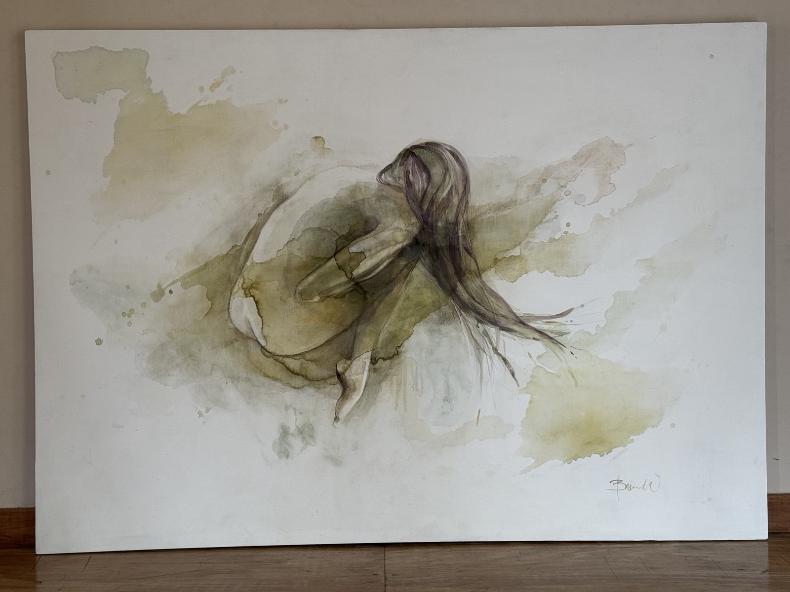 Large horizontal canvas of a curled figure with long hair in ochre and grey washes — NECTAR by Brenda Rodríguez